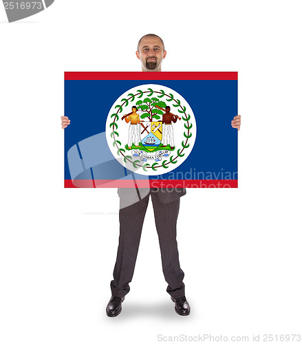 Image of Smiling businessman holding a big card or flag