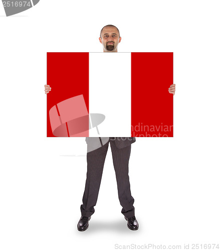 Image of Smiling businessman holding a big card or flag