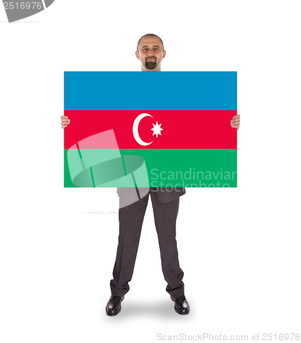 Image of Smiling businessman holding a big card or flag