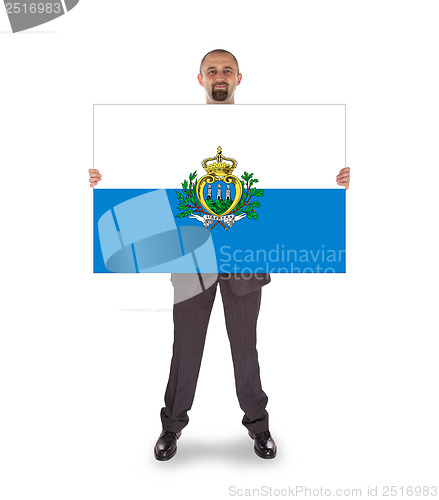 Image of Smiling businessman holding a big card or flag