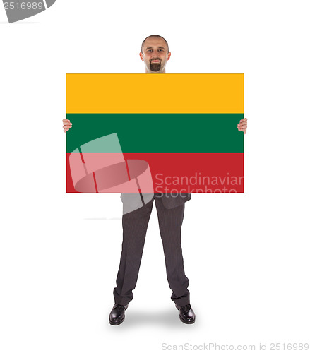 Image of Smiling businessman holding a big card or flag