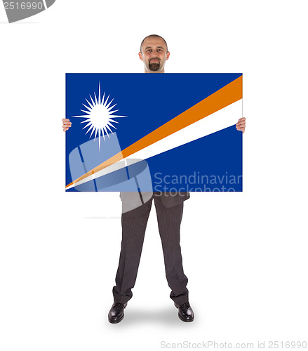 Image of Smiling businessman holding a big card or flag