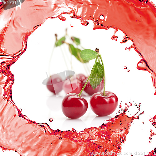 Image of Red cherry with leaves and juice isolated on white