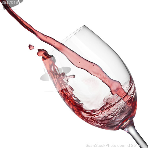Image of Splash of red wine in wineglass on white