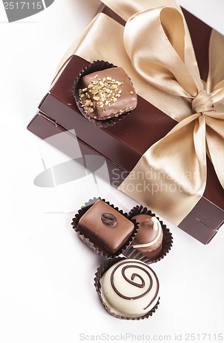 Image of brown box with candies and golden tape