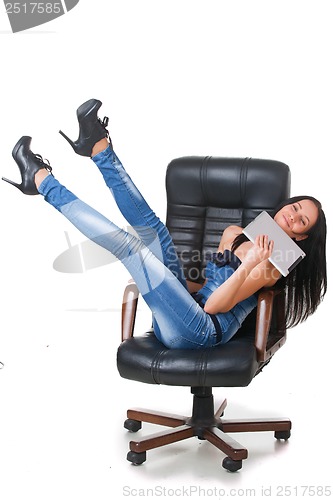 Image of Woman using a touch-pad PC sitting in chair