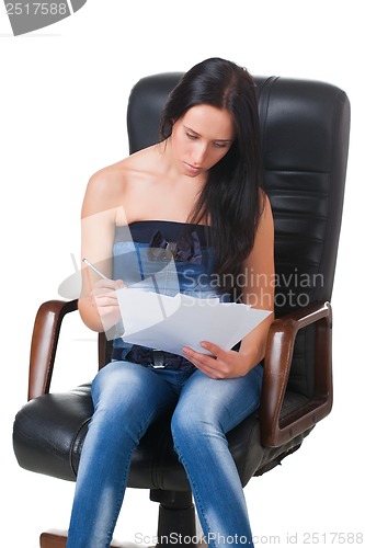 Image of Young girl with sheets of paper and pencil.