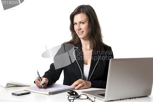 Image of Smiling businesswoman writing something