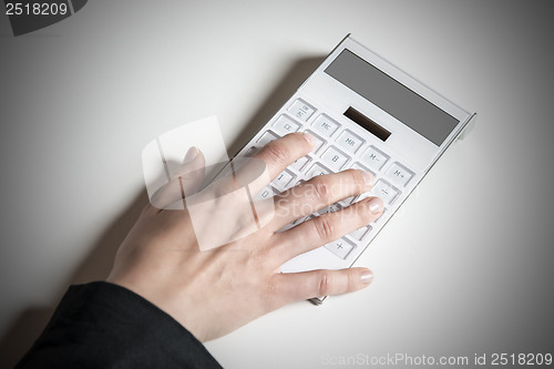 Image of Female hand with calculator