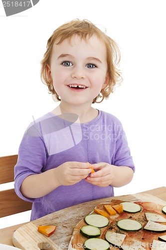 Image of cute laughing girl making pizza