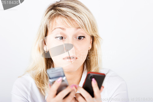 Image of Portrait girl with two mobile phones