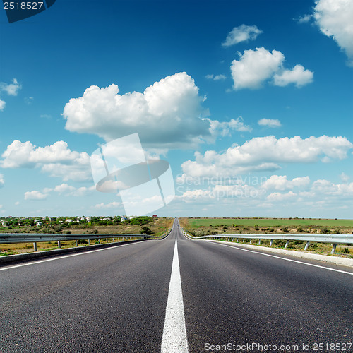 Image of asphalt road to horizon under cloudy sky