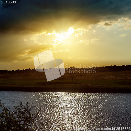 Image of dramatic yellow sunset over river