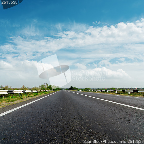 Image of black asphalt road and cloudy horizon