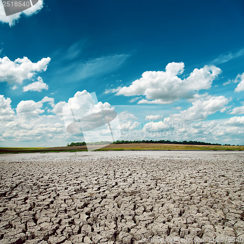 Image of blue dramatic sky over cracked desert