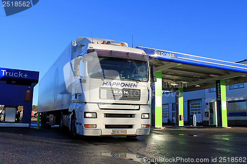 Image of White Man 18.480 Truck and Trailer at a Filling Station