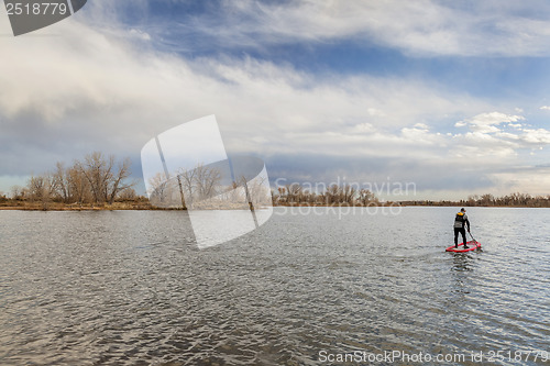 Image of stand up paddling in fall