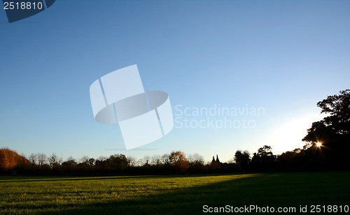 Image of Silhouetted hedgerow and oast houses at sundown