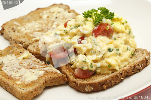 Image of Scrambled egg with parsley and tomato