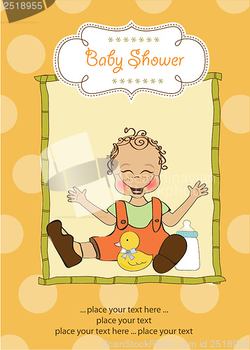 Image of baby boy playing with his duck toy, welcome baby card