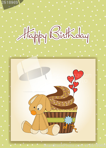 Image of birthday greeting card with cupcake and puppy toy