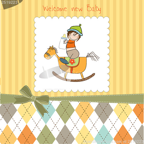 Image of baby boy shower shower with wood horse toy