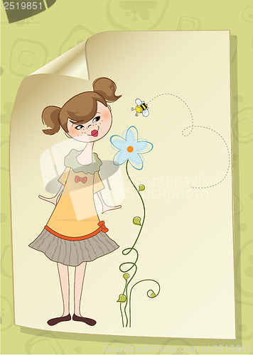 Image of small young lady who smells a flower