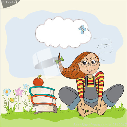Image of studious girl sitting barefoot in the grass