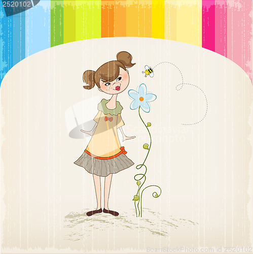 Image of small young lady who smells a flower