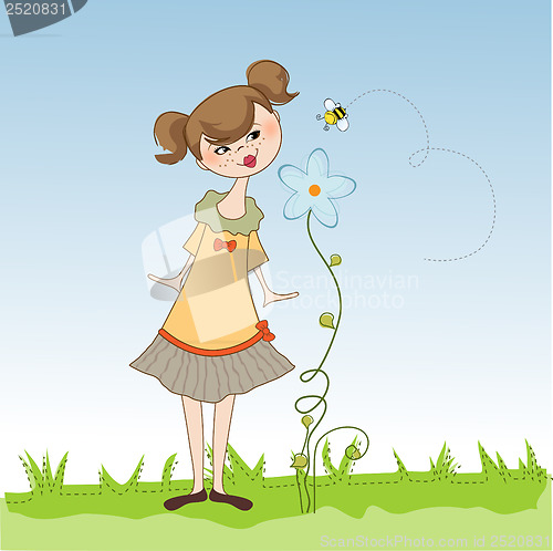 Image of small young lady who smells a flower