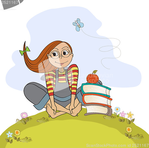 Image of studious girl sitting barefoot in the grass