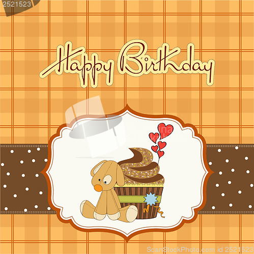 Image of birthday greeting card with cupcake and puppy toy