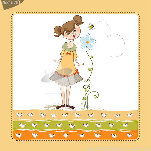 Image of small young lady who smells a flower