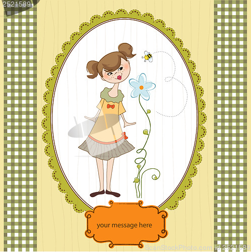 Image of small young lady who smells a flower