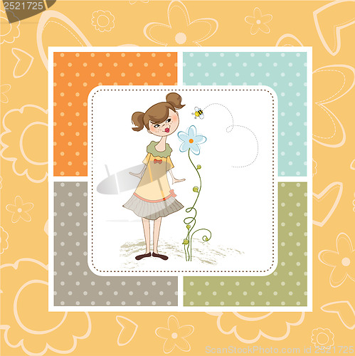 Image of small young lady who smells a flower