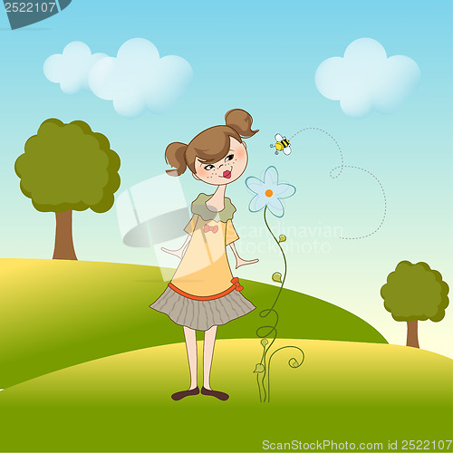 Image of small young lady who smells a flower