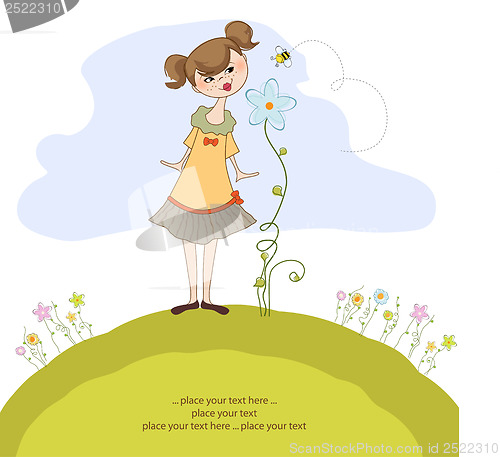 Image of small young lady who smells a flower