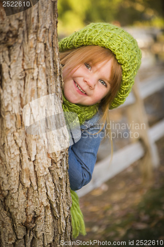 Image of Portrait of Cute Young Girl Wearing Green Scarf and Hat