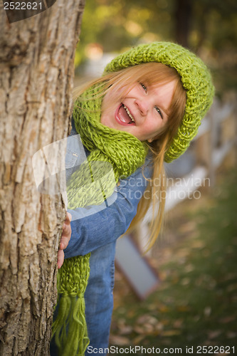 Image of Portrait of Cute Young Girl Wearing Green Scarf and Hat