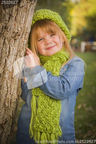 Image of Portrait of Cute Young Girl Wearing Green Scarf and Hat
