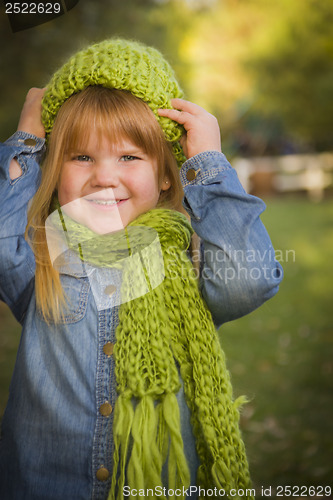 Image of Portrait of Cute Young Girl Wearing Green Scarf and Hat