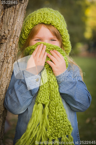 Image of Portrait of Cute Young Girl Wearing Green Scarf and Hat