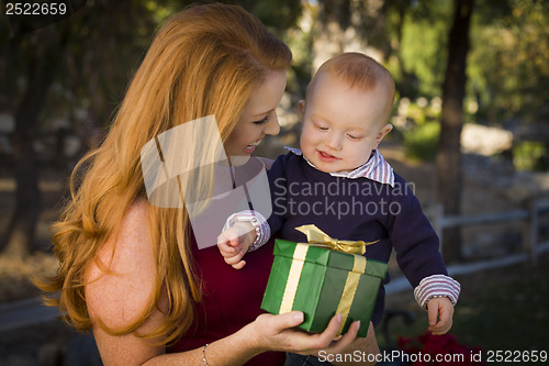 Image of Beautiful Young Mother and Baby with Christmas Gift