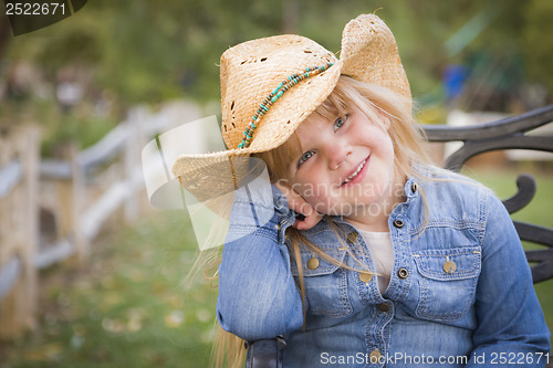 Image of Cute Young Girl Wearing Cowboy Hat Posing for Portrait Outside