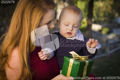Image of Beautiful Young Mother and Baby with Christmas Gift