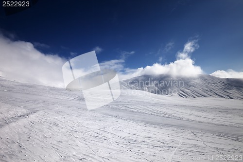 Image of Ski slope and mountains in clouds