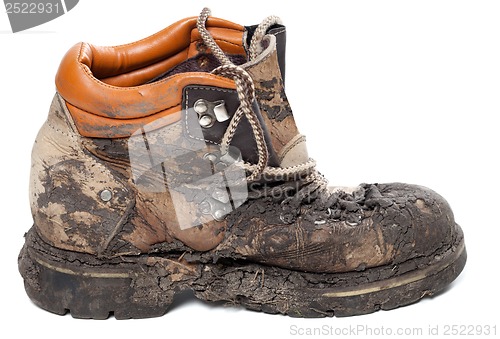 Image of Old dirty trekking boot. Side view.