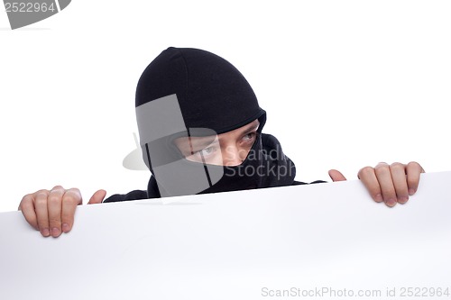 Image of Robber hiding behind a empty white  space for text