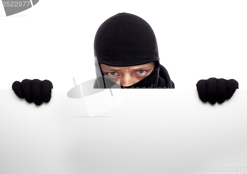 Image of Robber hiding behind a empty white  space for text