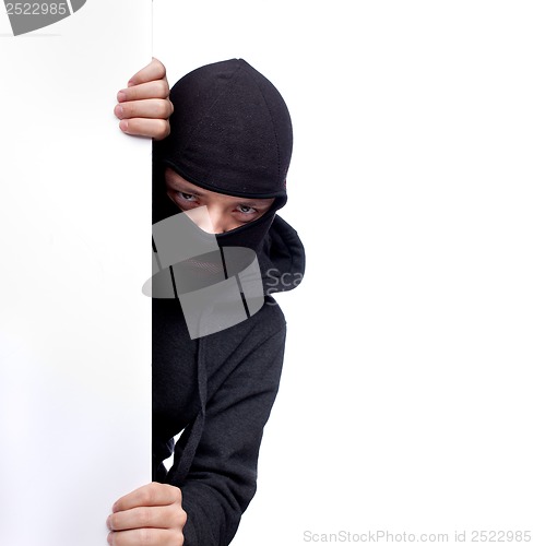 Image of Robber hiding behind a empty white  space for text